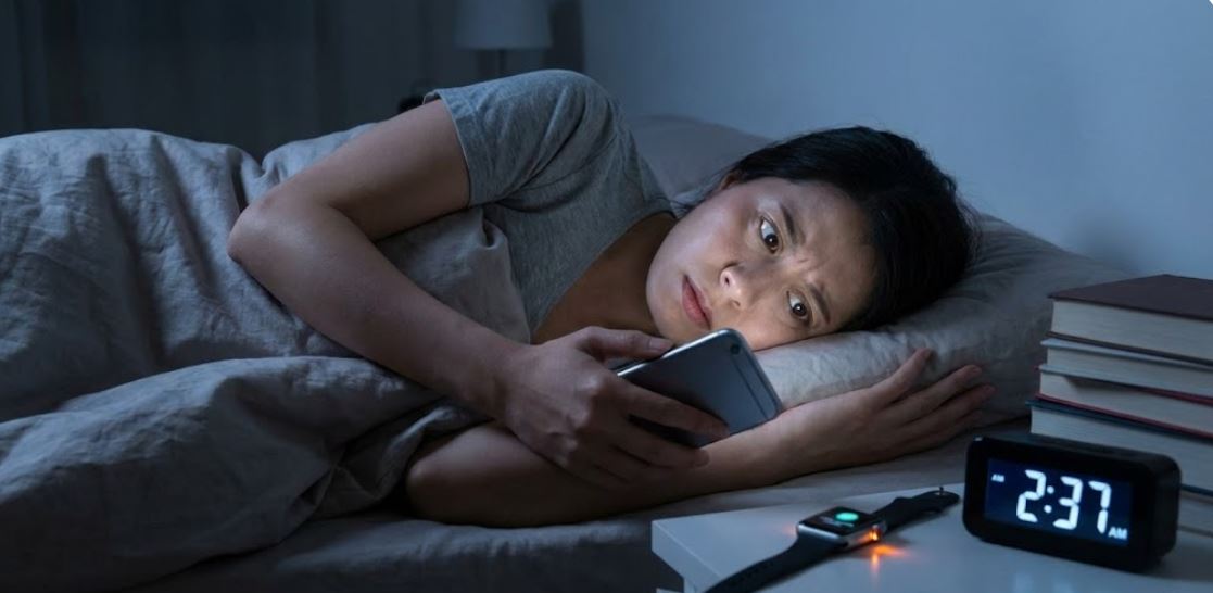 a woman lying on the bed, she can't sleep, it's late